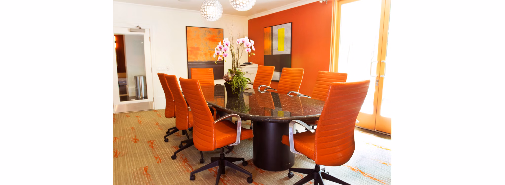 Meeting room with modern furniture and presentation screen at Legacy at Westwood Apartments, ideal for conferences and business gatherings