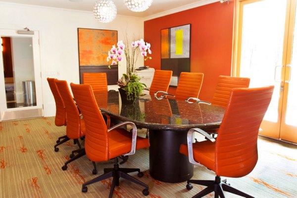 Meeting room with modern furniture and presentation screen at Legacy at Westwood Apartments, ideal for conferences and business gatherings