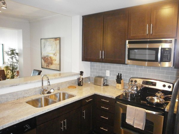 Modern kitchen with stainless steel appliances in Legacy at Westwood Apartments