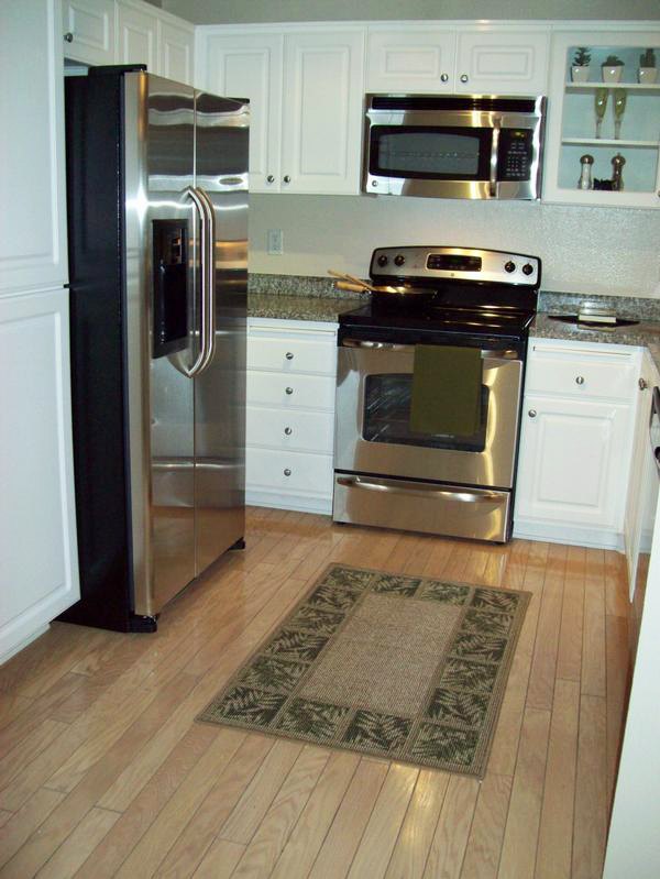Modern kitchen with stainless steel appliances and granite countertops in Legacy at Westwood Apartments