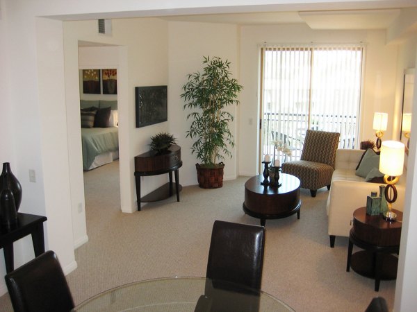 Living room with modern furnishings and large windows at Legacy at Westwood Apartments