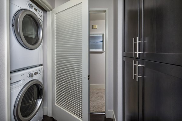 Laundry room featuring modern washers and dryers at Legacy at Westwood Apartments