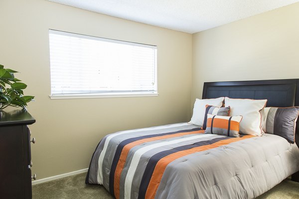 Cozy bedroom with modern decor in Ventura Terrace Apartments: Luxury living by Greystar