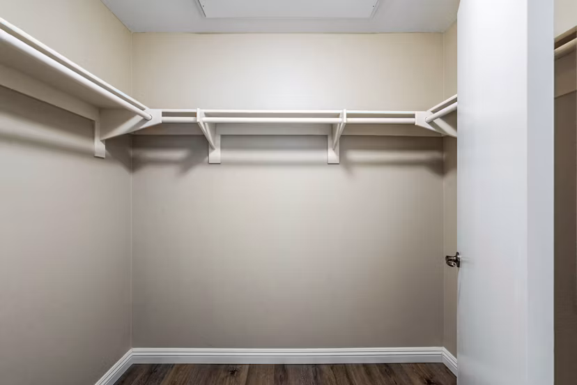 Walk-in bedroom closet with ample storage in Rolling Hills Gardens Apartments, luxury living experience by Greystar