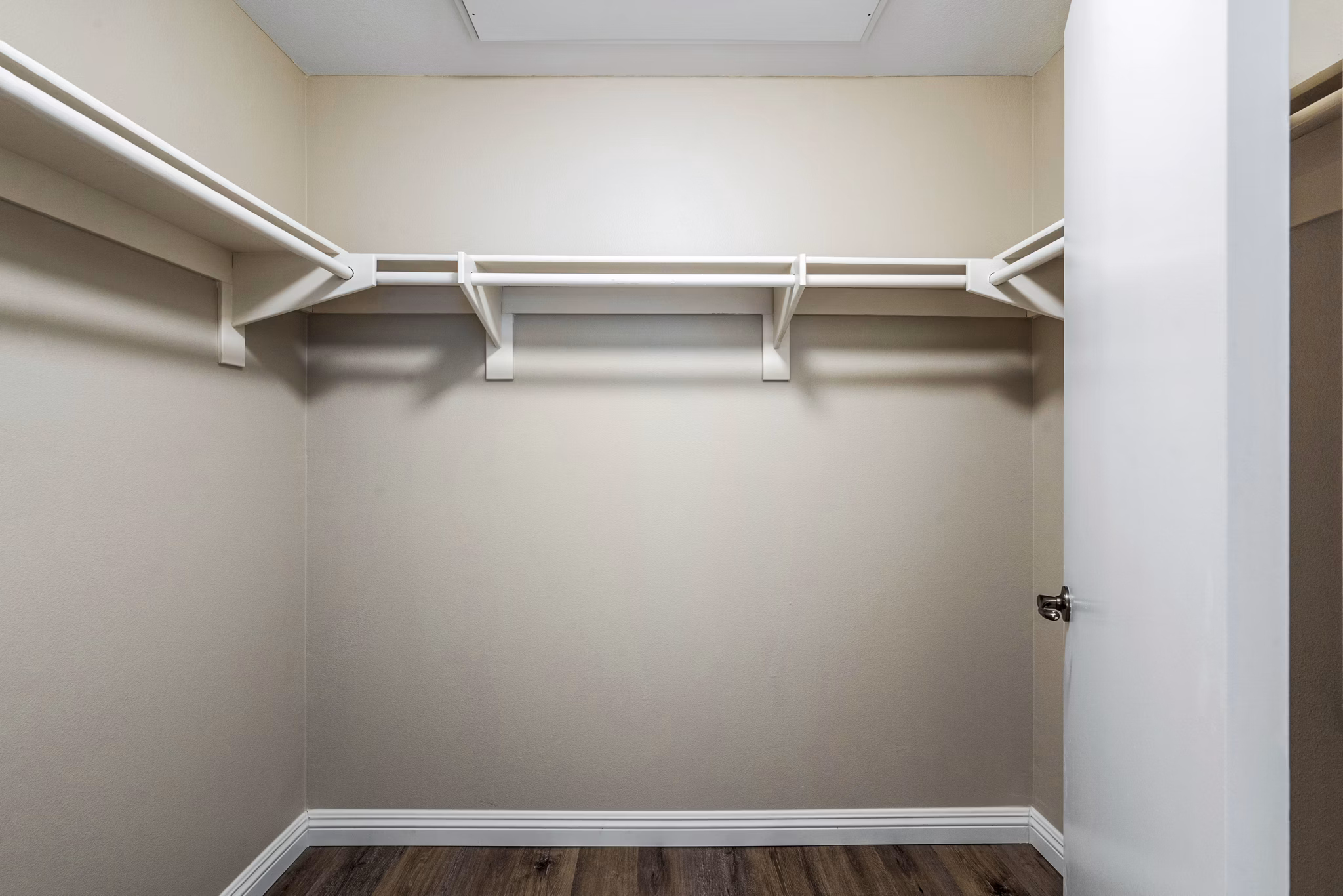 Walk-in bedroom closet with ample storage in Rolling Hills Gardens Apartments, luxury living experience by Greystar