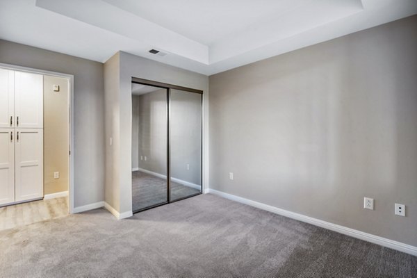 Cozy bedroom with modern dÃ©cor and ample natural light at Rolling Hills Gardens Apartments