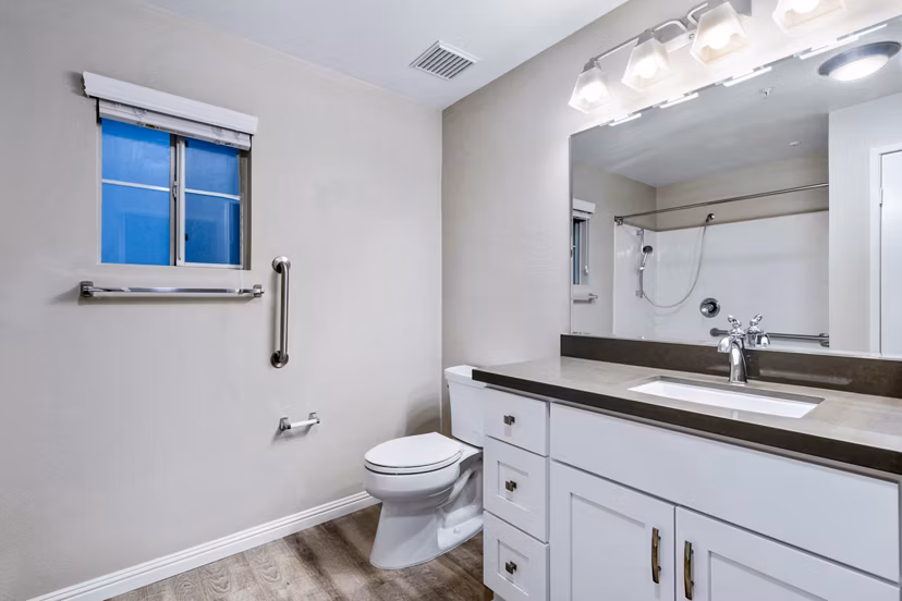 Bathroom with modern fixtures and large mirror in Rolling Hills Gardens Apartments