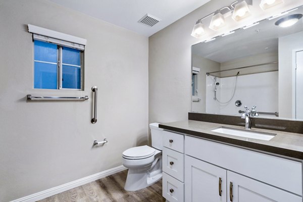 Bathroom with modern fixtures and large mirror in Rolling Hills Gardens Apartments