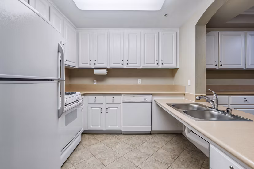 Clubhouse kitchen featuring stainless steel appliances and granite countertops at Rolling Hills Gardens Apartments, luxury living by Greystar