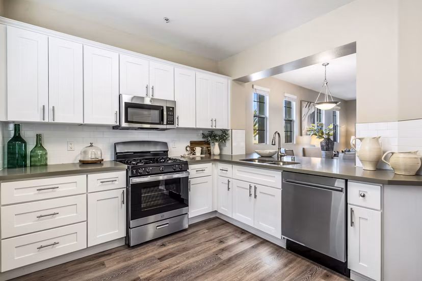 Modern kitchen with stainless steel appliances and granite countertops at Rolling Hills Gardens Apartments