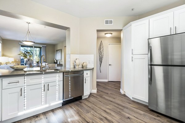 Modern kitchen with stainless steel appliances at Rolling Hills Gardens Apartments: luxury living in a Greystar community
