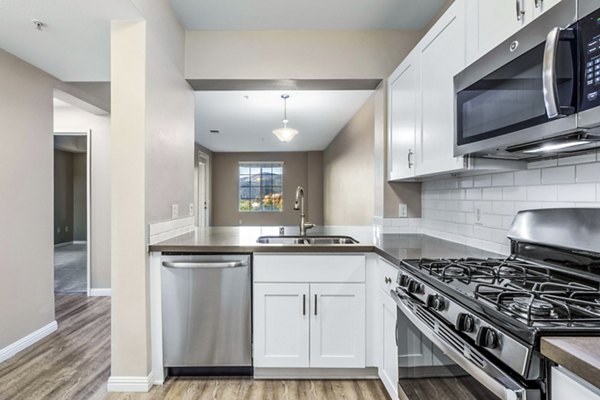 Modern kitchen featuring stainless steel appliances in Rolling Hills Gardens Apartments