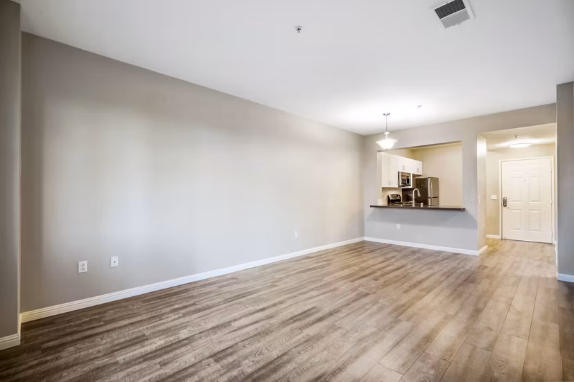Spacious living room with modern decor and ample natural light in Rolling Hills Gardens Apartments