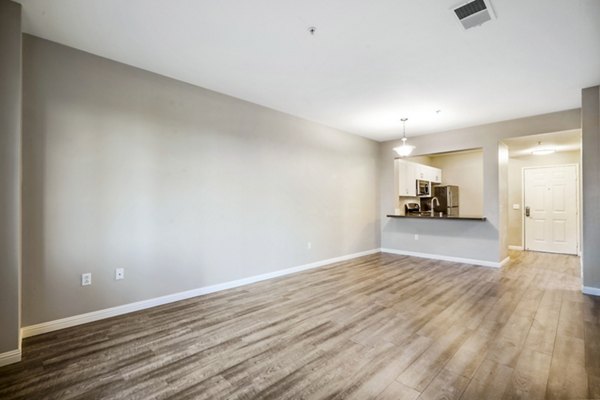 Spacious living room with modern decor and ample natural light in Rolling Hills Gardens Apartments