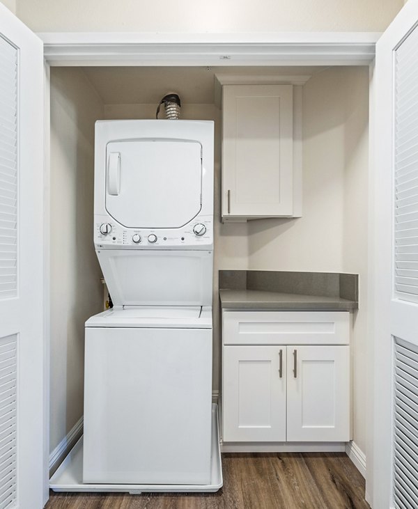 Laundry room with modern appliances at Rolling Hills Gardens Apartments