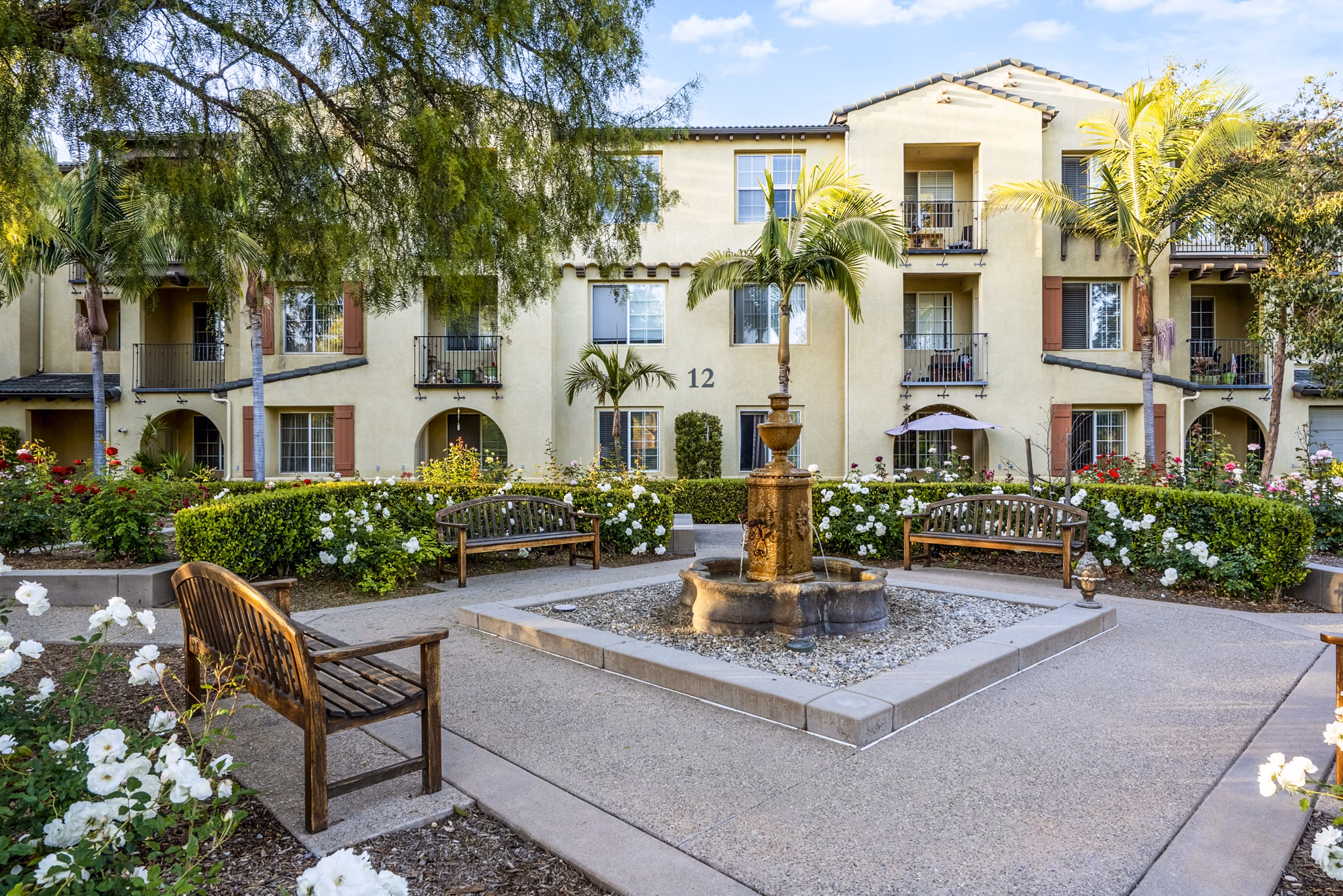 Courtyard with lush greenery at Rolling Hills Gardens Apartments