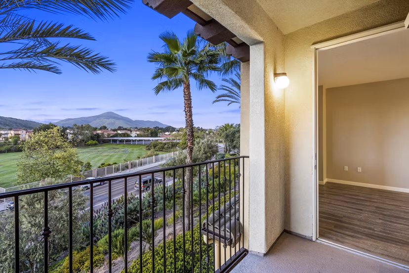 Spacious patio with seating area at Rolling Hills Gardens Apartments, offering a relaxing outdoor space with scenic views