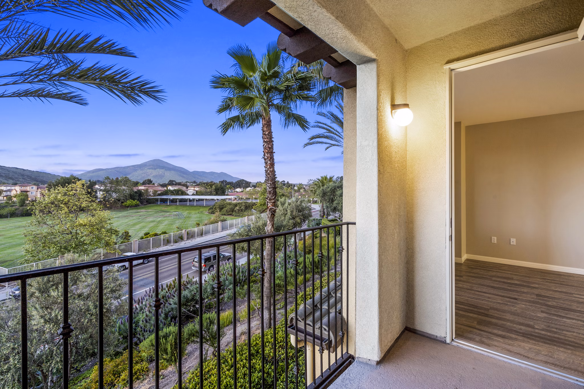 Spacious patio with seating area at Rolling Hills Gardens Apartments, offering a relaxing outdoor space with scenic views