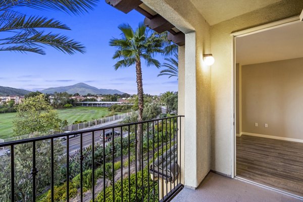 Spacious patio with seating area at Rolling Hills Gardens Apartments, offering a relaxing outdoor space with scenic views