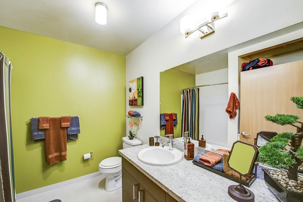 Bathroom featuring modern fixtures and stylish tilework in Link Apartments
