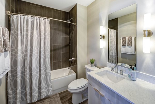 Modern bathroom with sleek fixtures at Link Apartments, featuring neutral tones and ample lighting for a luxurious living experience