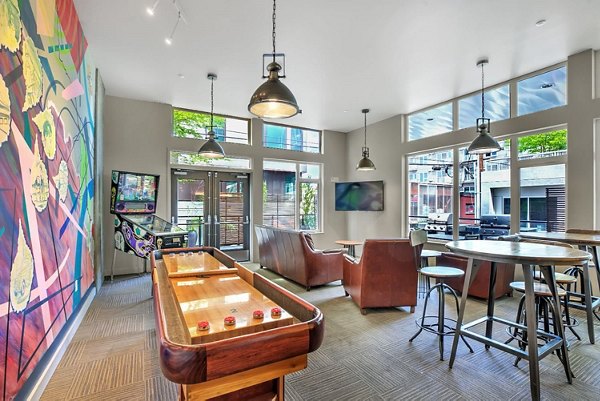 Contemporary game room with pool table and lounge seating at Link Apartments, ideal for socializing and relaxation
