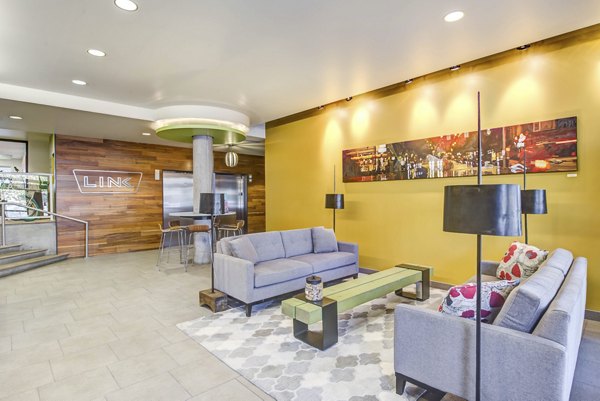 Contemporary clubhouse featuring spacious seating and modern decor at Link Apartments, ideal for social gatherings and relaxation