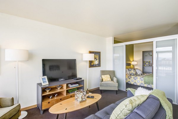 Modern living room with plush seating and natural lighting at Link Apartments