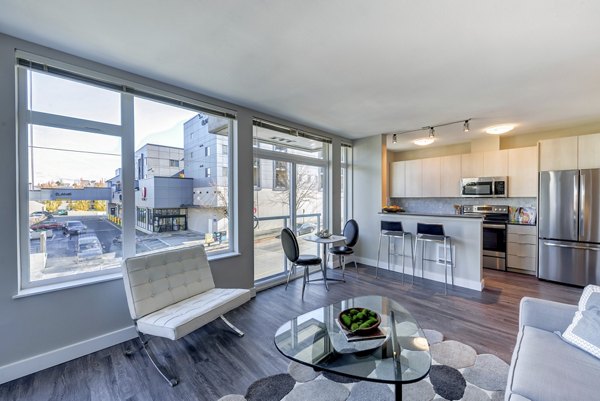 Living room with stylish decor and natural light at Mural Apartments