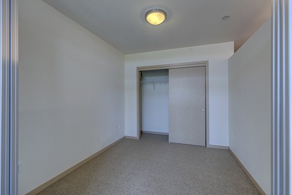 Cozy bedroom with modern furnishings at Prescott Apartments