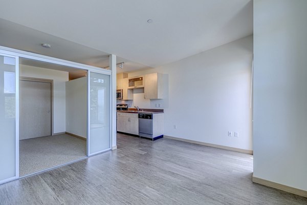 Dining room featuring elegant hardwood floors and modern lighting fixtures in Prescott Apartments, perfect for hosting guests