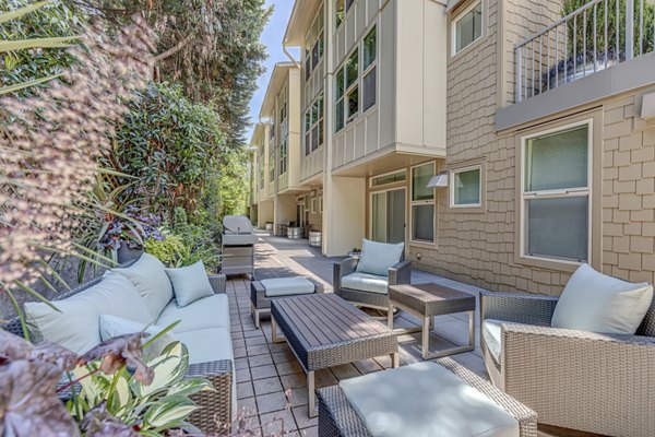 Patio with modern seating and greenery at Prescott Apartments