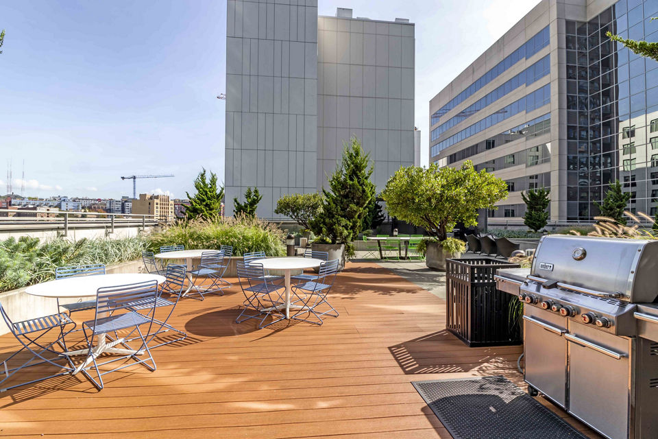 Outdoor grill area featuring modern barbecue stations at Aspira Apartments in downtown Seattle Perfect for outdoor gatherings and entertainment