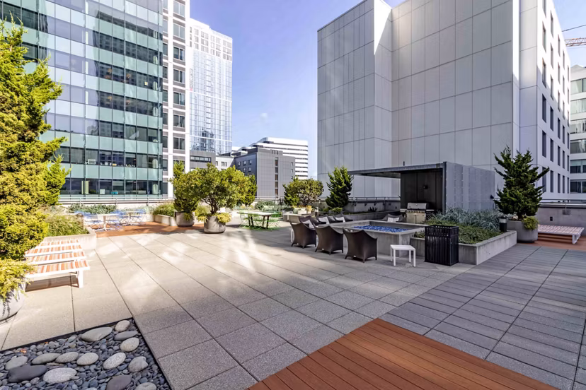 Courtyard featuring lush landscaping and seating areas at Aspira Apartments
