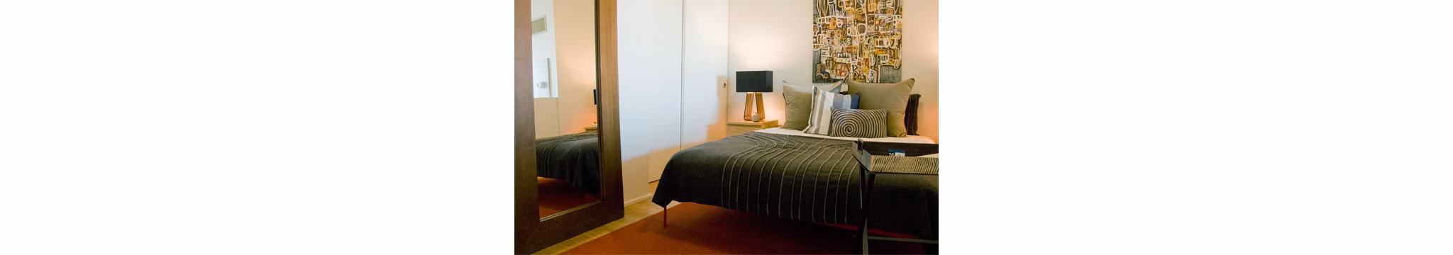 Modern bedroom with sleek furnishings at Cyan PDX Apartments