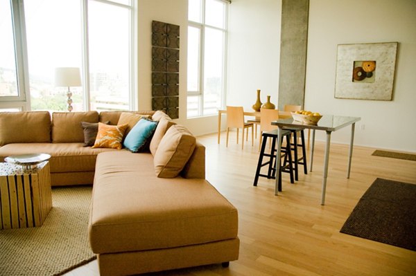 Living room adorned with stylish dÃ©cor and expansive windows at Cyan PDX Apartments, a Greystar luxury apartment community