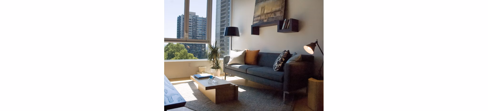 Spacious living room with modern furnishings at Cyan PDX Apartments, offering luxury comfort and style