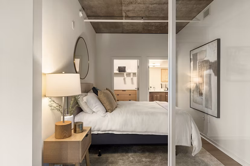 Cozy bedroom with modern furnishings at Tenth&G Apartments, offering luxury living in the heart of the city