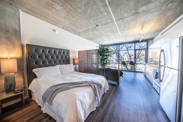 Cozy bedroom with modern furnishings at Tenth&G Apartments, offering luxury living in the heart of the city