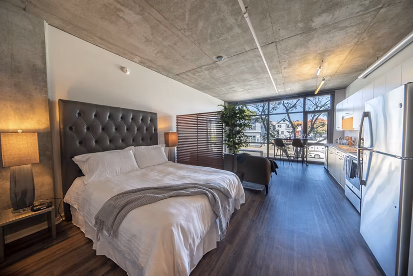 Cozy bedroom with modern furnishings at Tenth&G Apartments