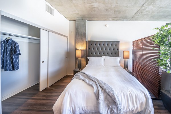Cozy bedroom with modern furnishings at Tenth&G Apartments