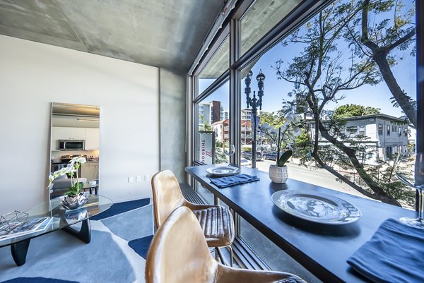 Dining room featuring stylish furniture and modern lighting at Tenth&G Apartments