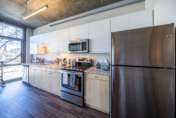 Modern kitchen with stainless steel appliances at Tenth&G Apartments