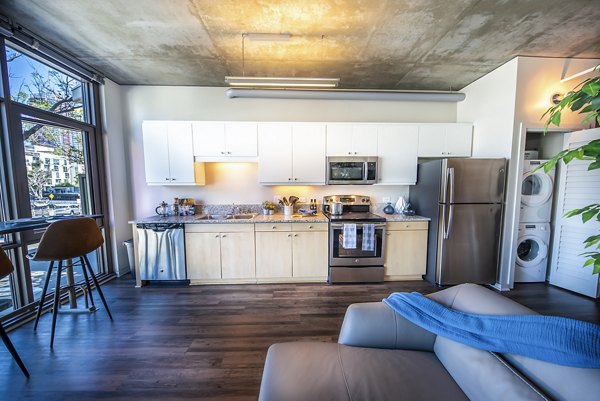 Modern kitchen with stainless steel appliances at Tenth&G Apartments