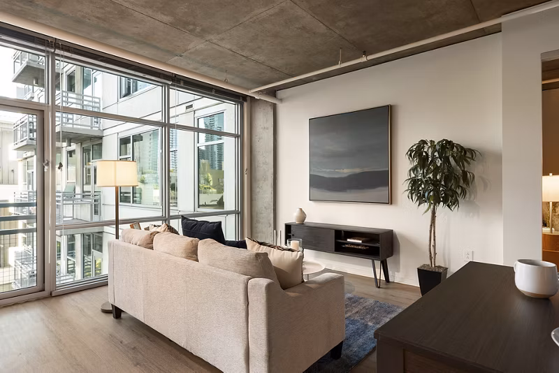 Elegant living room with contemporary design and natural light at Tenth&G Apartments, Greystar luxury apartments in urban setting