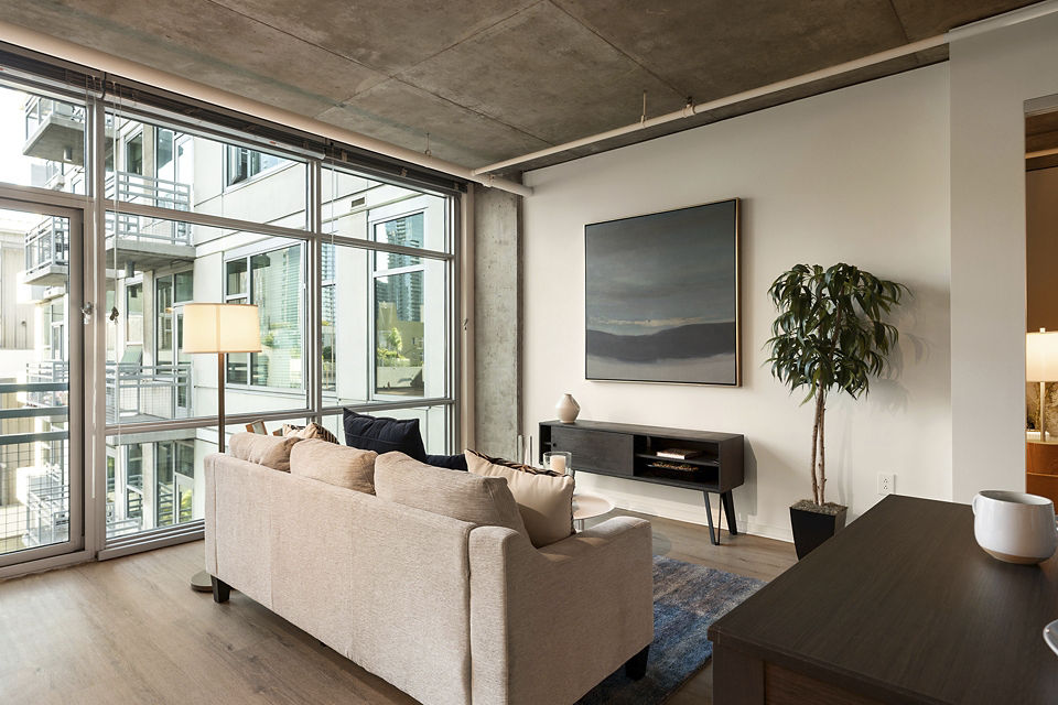 Elegant living room with contemporary design and natural light at Tenth&G Apartments, Greystar luxury apartments in urban setting