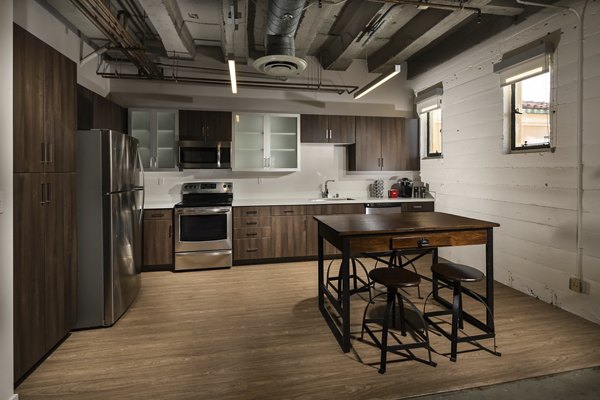 Modern kitchen with stainless steel appliances at Holly Street Village Apartments