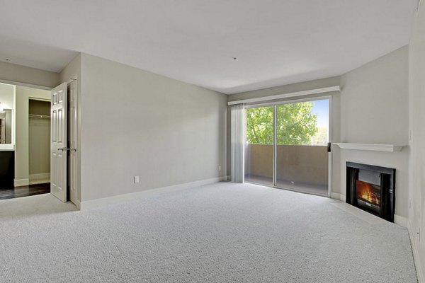 Modern living room with cozy seating and stylish decor at Holly Street Village Apartments, Greystar luxury community