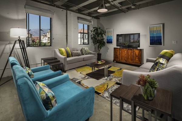 Living room with modern decor at Holly Street Village Apartments featuring cozy seating and stylish design elements