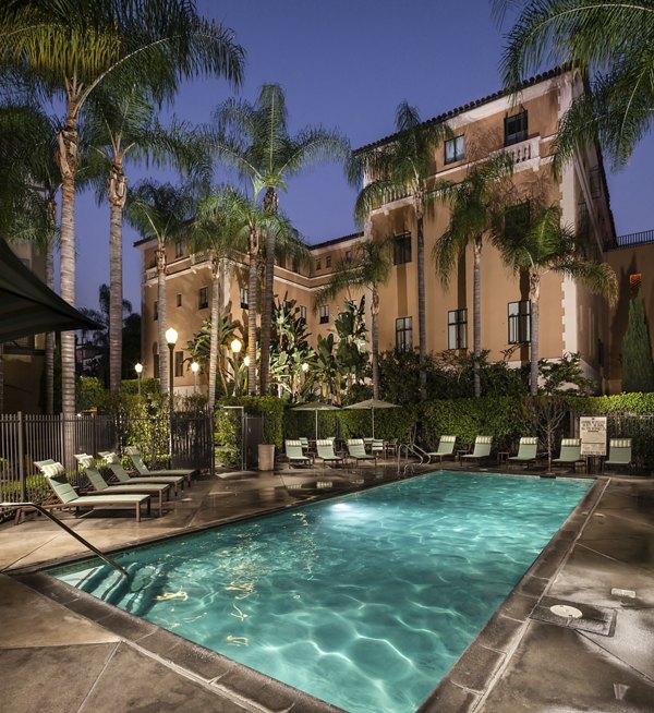 Scenic pool with lounge chairs at Holly Street Village Apartments offering a luxury outdoor experience